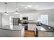 Updated kitchen featuring stainless appliances, granite counters, a kitchen island, and stylish pendant lights at 66 Reed Ne St, Concord, NC 28025