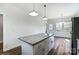 Open concept kitchen with a granite island, stainless steel appliances and wood floors at 66 Reed Ne St, Concord, NC 28025