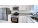 Modern kitchen featuring stainless steel appliances, granite countertops and white cabinets at 66 Reed Ne St, Concord, NC 28025