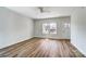 Bright living room featuring laminate floors, fresh white walls, and a ceiling fan for added comfort at 66 Reed Ne St, Concord, NC 28025