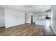 Spacious living area with wood-look floors flowing into a modern kitchen with stainless steel appliances at 66 Reed Ne St, Concord, NC 28025