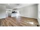 Open-concept living space boasts wood floors and abundant natural light, flowing into the modern kitchen at 66 Reed Ne St, Concord, NC 28025