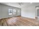 Bright living room with wood-look floors, white trim, and ample natural light from large windows at 66 Reed Ne St, Concord, NC 28025