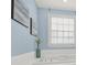 Bright bathroom featuring modern art, a garden tub, and crisp natural light from a window at 7224 St Clair Dr, Charlotte, NC 28270