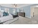 Comfortable bedroom featuring blue walls, a decorative dresser, and soft natural light at 7224 St Clair Dr, Charlotte, NC 28270
