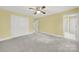 Bright bedroom with neutral carpet, ceiling fan and white trim at 7224 St Clair Dr, Charlotte, NC 28270