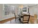 Breakfast nook with a round table and four chairs under a pendant light by a large window at 7224 St Clair Dr, Charlotte, NC 28270