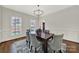 Formal dining room with hardwood floors, wainscoting, and modern lighting at 7224 St Clair Dr, Charlotte, NC 28270