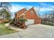Beautiful red brick home features an attached garage and well manicured landscaping at 7224 St Clair Dr, Charlotte, NC 28270