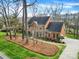 Elegant brick home on a well-maintained lot, featuring a long driveway and lush landscaping at 7224 St Clair Dr, Charlotte, NC 28270