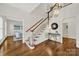 Inviting foyer with hardwood floors, staircase, and elegant lighting fixture at 7224 St Clair Dr, Charlotte, NC 28270