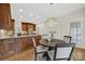 Bright kitchen with a breakfast nook with wood table, wooden cabinets and granite counters at 7224 St Clair Dr, Charlotte, NC 28270