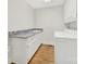 Bright laundry room with ample counter space, storage cabinets, and modern washer and dryer at 7224 St Clair Dr, Charlotte, NC 28270