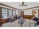 Cozy living room featuring dark wood trim, large windows, stylish seating, and an area rug at 7224 St Clair Dr, Charlotte, NC 28270