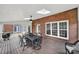 Bright screened-in porch with brick accent wall and view to another deck, ideal for outdoor enjoyment at 7224 St Clair Dr, Charlotte, NC 28270