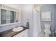 Bright bathroom featuring a dark wood vanity, white sink, and shower with curtain at 7300 Falkirk Pl, Charlotte, NC 28270
