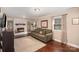 Spacious living room with fireplace, built-in bookshelves, and hardwood floors at 7300 Falkirk Pl, Charlotte, NC 28270
