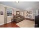 Comfortable living room with hardwood floors, and a green sofa at 7300 Falkirk Pl, Charlotte, NC 28270