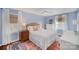 Calm bedroom with soft blue walls, white trim, hardwood floors and many windows at 7300 Falkirk Pl, Charlotte, NC 28270