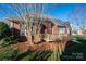 This backyard is lush with trees and a small deck at 8018 Cotton St, Harrisburg, NC 28075