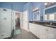 Modern bathroom with a glass-enclosed shower, double vanity with granite countertops, and stylish tile flooring at 8018 Cotton St, Harrisburg, NC 28075