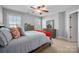 Bedroom with light gray walls, neutral carpet, and natural light from two windows at 8018 Cotton St, Harrisburg, NC 28075