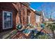 Inviting deck with brick facade, decorative rug, and cozy seating for outdoor relaxation and enjoyment at 8018 Cotton St, Harrisburg, NC 28075