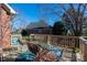 Wooden outdoor deck showcases a vibrant rug and comfortable seating with nice backyard view at 8018 Cotton St, Harrisburg, NC 28075