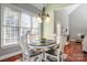 Dining area with hardwood floors, natural light from large windows, and direct access to the living room at 8018 Cotton St, Harrisburg, NC 28075