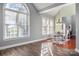 Bright dining area with hardwood floors and abundant natural light from multiple windows overlooking the outdoors at 8018 Cotton St, Harrisburg, NC 28075