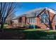 Charming brick home with a spacious backyard, wooden deck, and well-maintained landscaping at 8018 Cotton St, Harrisburg, NC 28075