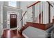 Inviting foyer with hardwood floors and staircase, showcasing a bright entrance at 8018 Cotton St, Harrisburg, NC 28075