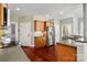 Well-equipped kitchen featuring granite countertops, stainless steel appliances, and dark wood floors at 8018 Cotton St, Harrisburg, NC 28075