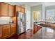 Updated kitchen featuring stainless steel refrigerator, wooden cabinets, and laundry area at 8018 Cotton St, Harrisburg, NC 28075
