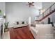 Spacious living room with tall ceiling, wood floors, a fireplace, and a staircase to the upper level at 8018 Cotton St, Harrisburg, NC 28075