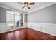 Formal living room features wood floors, elegant molding, and a large arched window with great natural light at 8018 Cotton St, Harrisburg, NC 28075