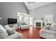Cozy living room with vaulted ceiling, fireplace, hardwood floors, and comfortable seating arrangements at 8018 Cotton St, Harrisburg, NC 28075