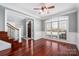 Elegant living room with wood floors, large arched window, and view to the foyer and staircase at 8018 Cotton St, Harrisburg, NC 28075