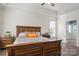 Spacious main bedroom with hardwood floors, neutral paint, and a full bathroom, creating a serene retreat at 8018 Cotton St, Harrisburg, NC 28075