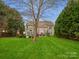 Lush backyard with mature landscaping, a cozy patio, and plenty of space for outdoor activities at 809 Circle Trace Rd, Monroe, NC 28110