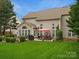 Expansive backyard featuring a patio, lush lawn, mature trees, and outdoor dining area at 809 Circle Trace Rd, Monroe, NC 28110