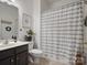 Well-lit bathroom featuring a shower with a stylish striped curtain and modern vanity at 809 Circle Trace Rd, Monroe, NC 28110