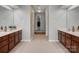 Spacious bathroom featuring tile floors and separate and vanities with dark wood cabinets at 809 Circle Trace Rd, Monroe, NC 28110