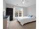 Well-lit bedroom featuring neutral tones, a ceiling fan, and ample natural light from two windows at 809 Circle Trace Rd, Monroe, NC 28110