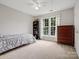 Comfortable bedroom features a neutral color scheme and two windows for ample natural light at 809 Circle Trace Rd, Monroe, NC 28110
