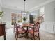 Formal dining area with classic wood furniture, neutral walls, and view of the front entrance at 809 Circle Trace Rd, Monroe, NC 28110