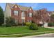 Two-story brick home with manicured lawn and mature landscaping under a blue sky at 809 Circle Trace Rd, Monroe, NC 28110