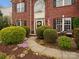 Charming brick home featuring lush landscaping and a welcoming walkway to the front door at 809 Circle Trace Rd, Monroe, NC 28110