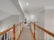 Upstairs hallway offers views into other rooms and features neutral paint and carpeting at 809 Circle Trace Rd, Monroe, NC 28110