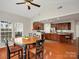 Open concept kitchen and dining area featuring hardwood floors, granite counters and stainless appliances at 809 Circle Trace Rd, Monroe, NC 28110